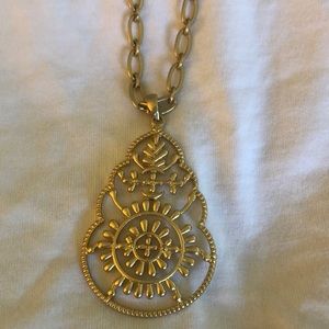 Gold colored pendant necklace.